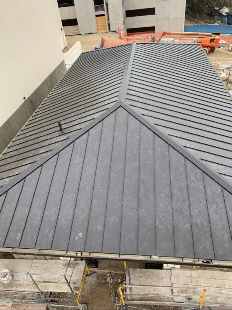 Commercial metal roof construction with crane equipment in Red Lion